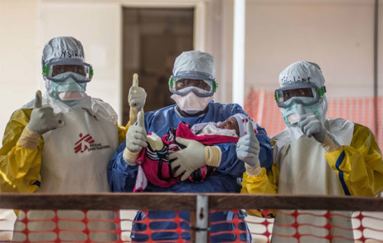 Den lille pige Nubia bliver her båret ud fra et hospital i Guinea, efter at hun har overlevet ebola
