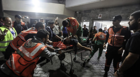 A Palestinian civil defence officer injured in Israeli attacks is given cardiopulmonary resuscitation on a stretcher at Al-Shifa Hospital in Gaza Stri - Palestinian Territories