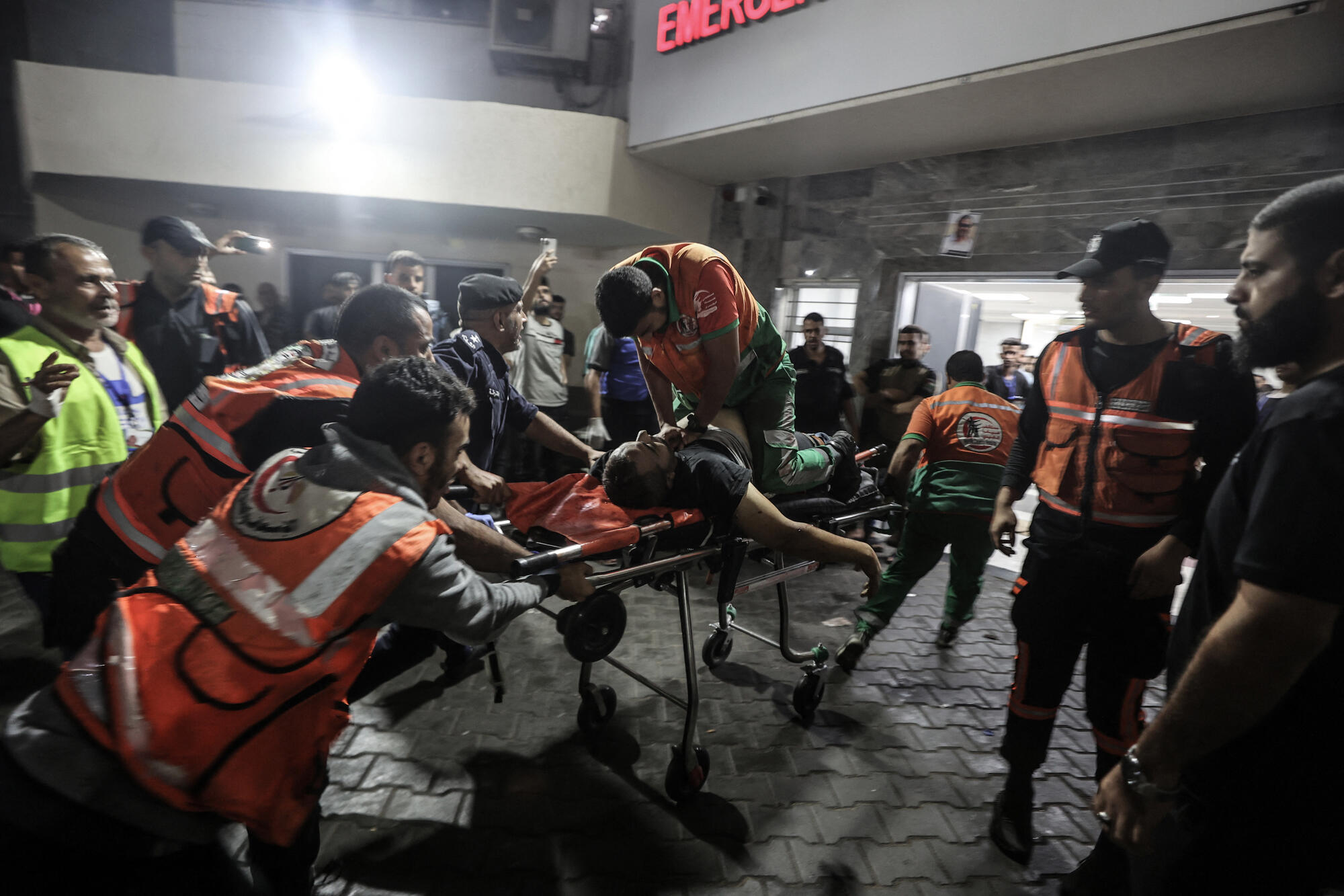 A Palestinian civil defence officer injured in Israeli attacks is given cardiopulmonary resuscitation on a stretcher at Al-Shifa Hospital in Gaza Stri - Palestinian Territories