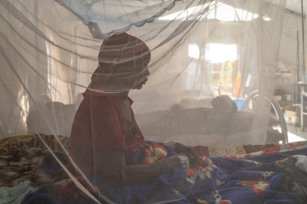 TAWILA, North Darfur, Sudan — March 2026: A female patient sits under mosquito netting at the MSF-run Hospital in Tawila, one of the few functioning m - Sudan