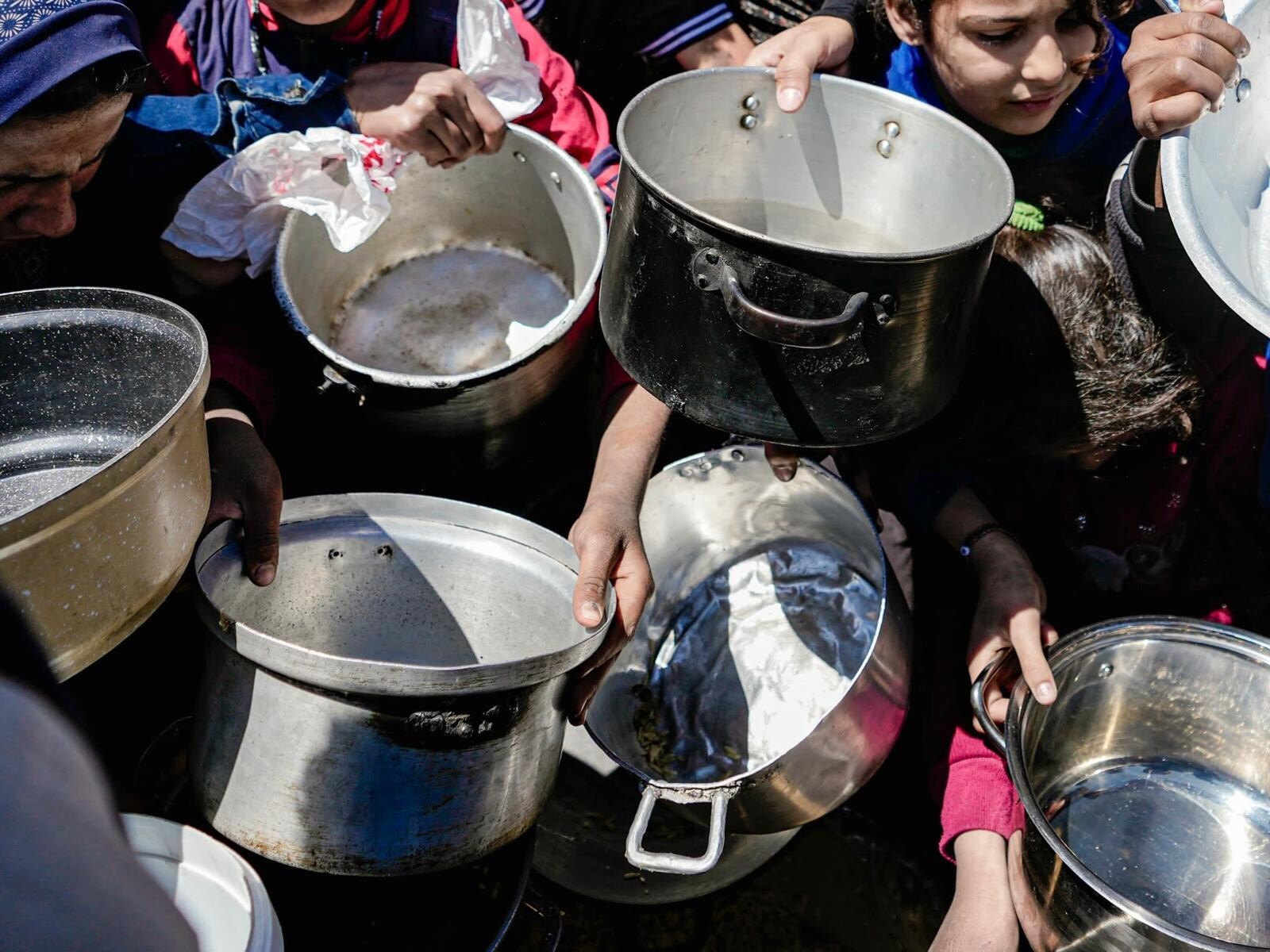 Kids holding their empty pots at a community kitchen in Northern Gaza - Palestinian Territories